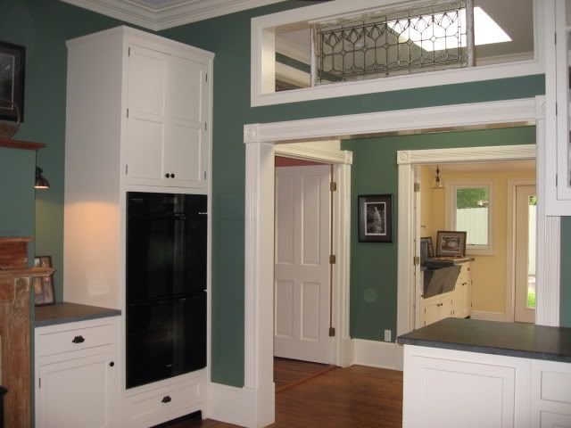 Miele ovens and transom of leaded glass/matches transom over bedroom entrance
