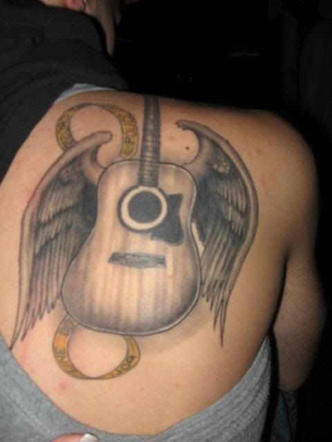 guitar and wings tattoo on back-959