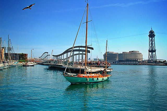 Rambla de Mar Lightweight Bridge and Sailing Boat in Barcelona, Spain [enlarge]